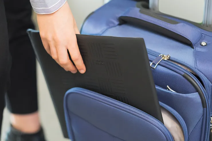 Folded Travel Ledge being packed into rolling luggage