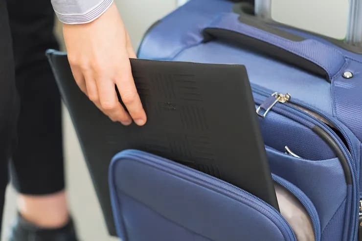 Folded Travel Ledge being packed into rolling luggage