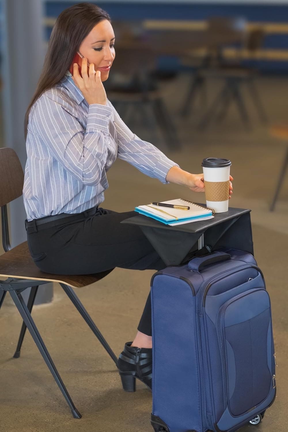 Seated traveler using Travel Ledge for a notebook and drink thumbnail