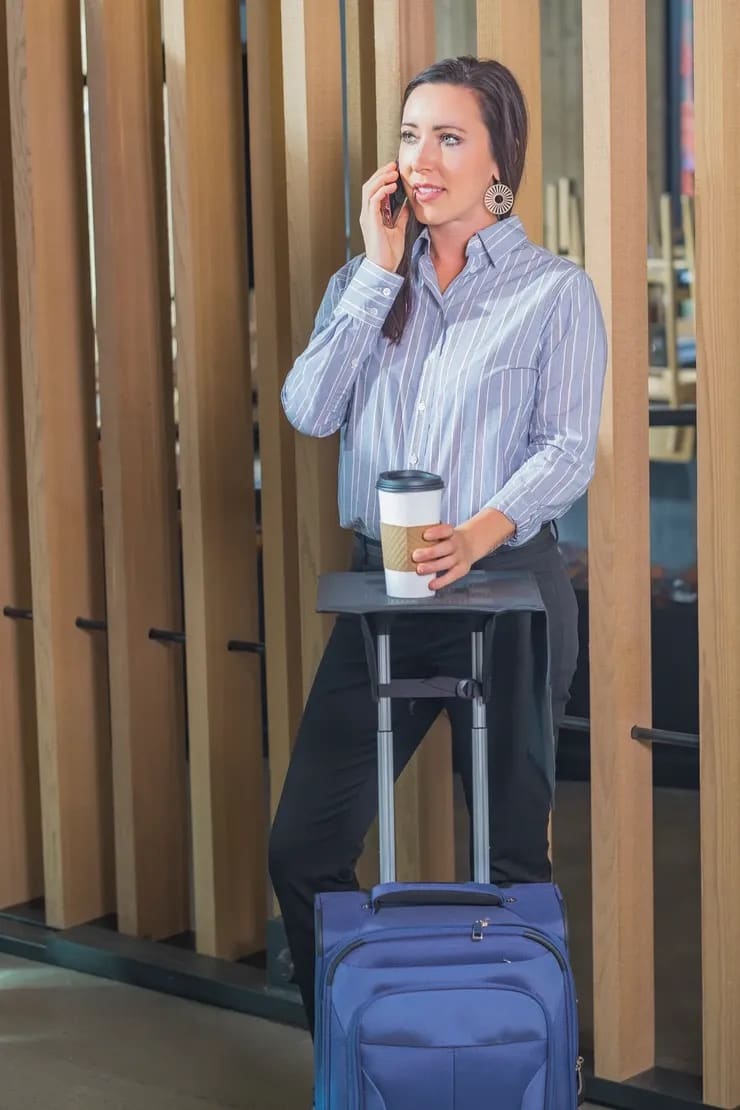 Rolling luggage with two separate telescoping handle posts supporting Travel Ledge